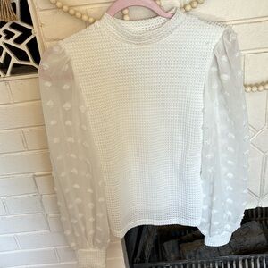 Women’s top. Sleeves are sheer.